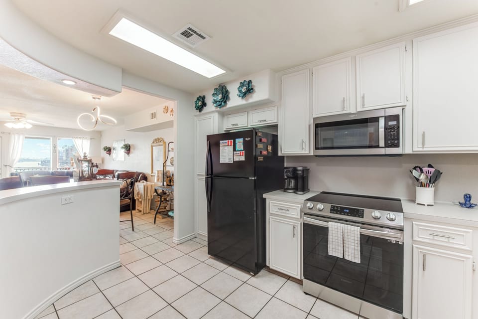 Your fully equipped kitchen awaits with modern appliances, bright skylights, and easy flow into the living space for memorable meals.