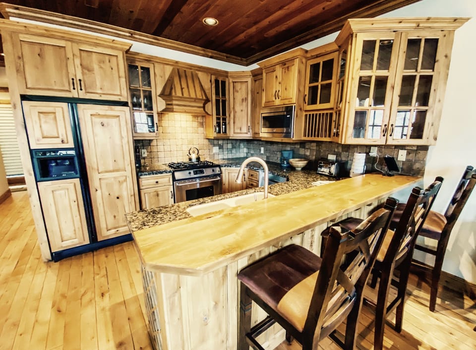Full kitchen with breakfast counter provides lots of space for cooking.