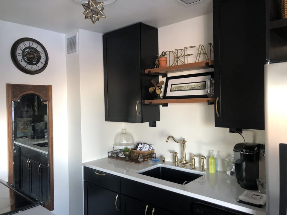 Kitchen with Keurig, drip coffee pot, microwave, oven, and dishwasher.