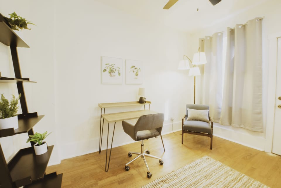 The dedicated workspace has a desk and chair.