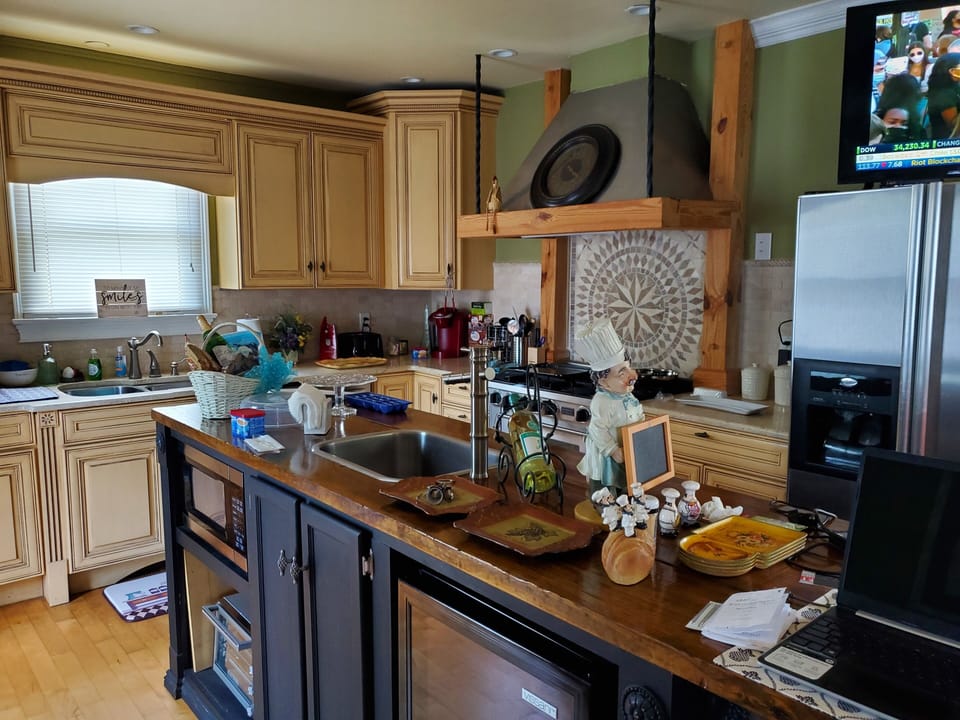 Kitchen; long island with 4 high bar chairs, 43 in TV