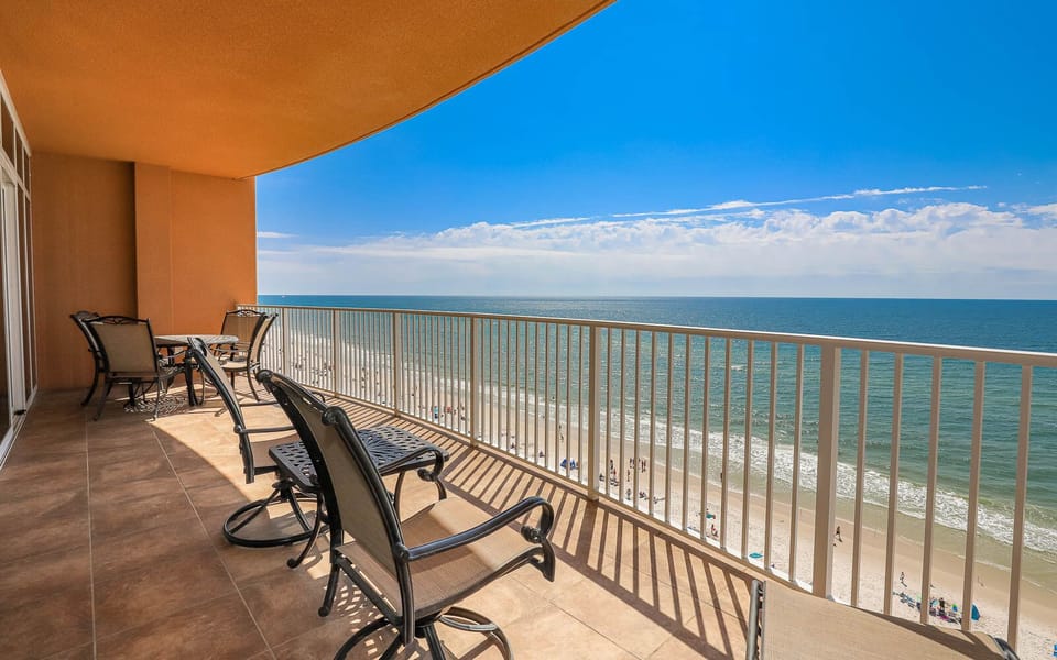 Relax on the balcony, enjoying the expansive view of the coastline and gentle waves below