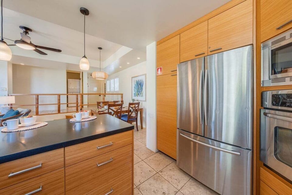 Cook and gather around a stylish island framed by pendant lights and warm wood tones.
