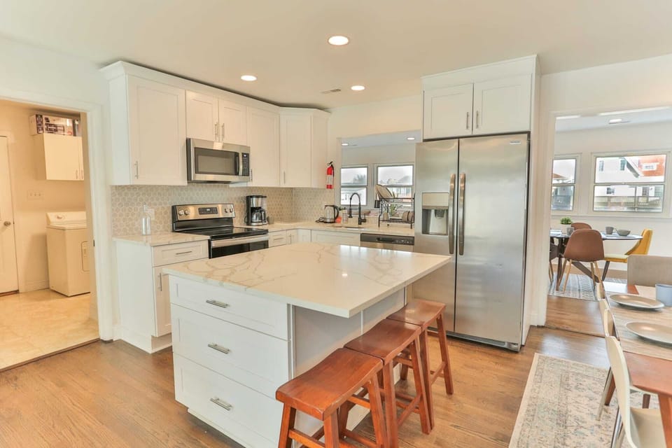 Fully renovated kitchen with full-size stainless steel appliances to cook in comfort for your entire group! Bar seating for three included as well. The fridge includes an ice maker and filtered water.