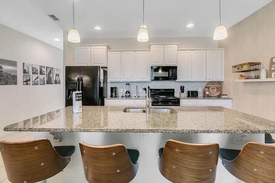 Luxuriously updated fully stocked kitchen with granite countertops. 