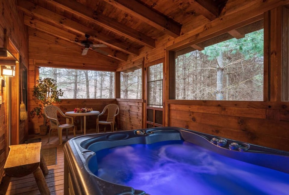 The hot tub provides a peaceful escape surrounded by the gentle sounds of nature from the forest.