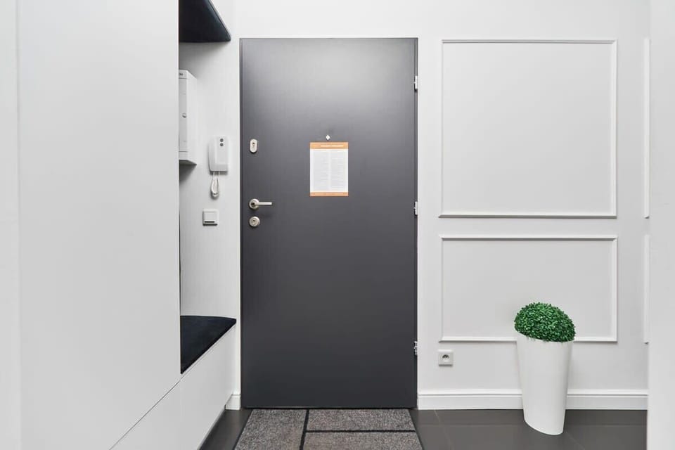 Bright and spacious hallway with built-in closet and soft seating. 