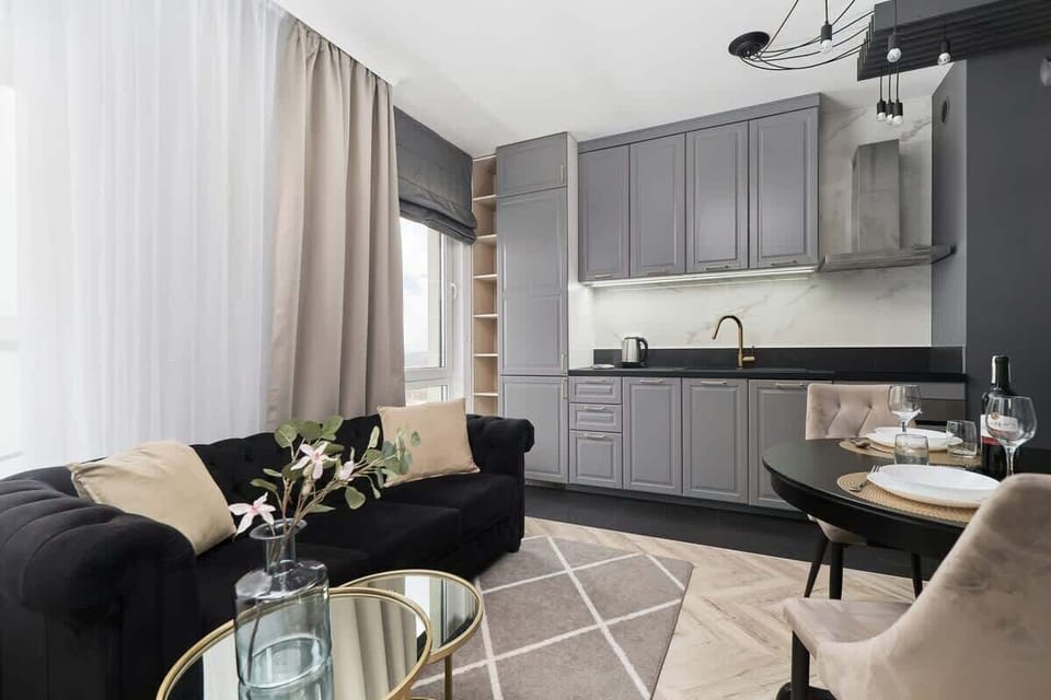 A wider view of the lounge area combined with the kitchenette. The whole is stylish and elegant.