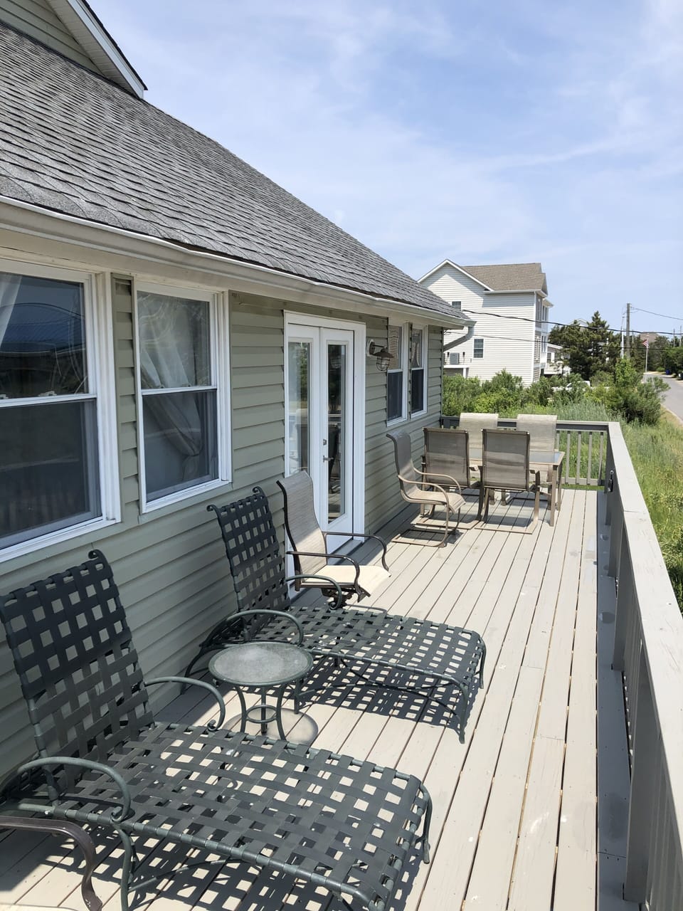 1st floor gated front deck with seating areas.