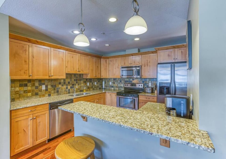 Fully equipped kitchen with fridge and microwave