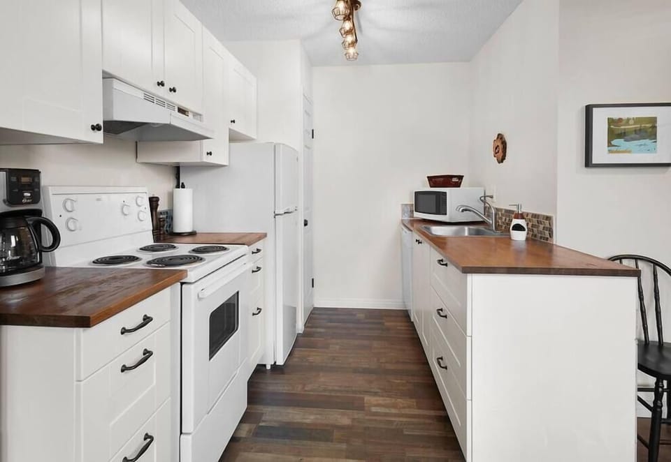 Kitchen with stove, oven, coffee maker, refrigerator