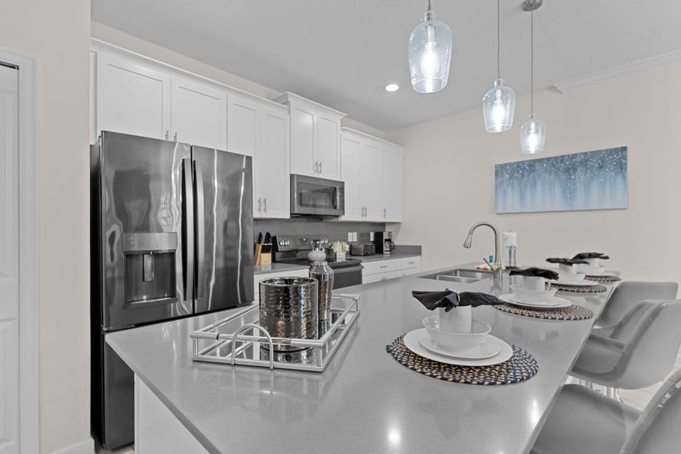 Your modern kitchen features sleek quartz countertops, stainless steel appliances, and elegant pendant lighting—perfect for preparing memorable meals.