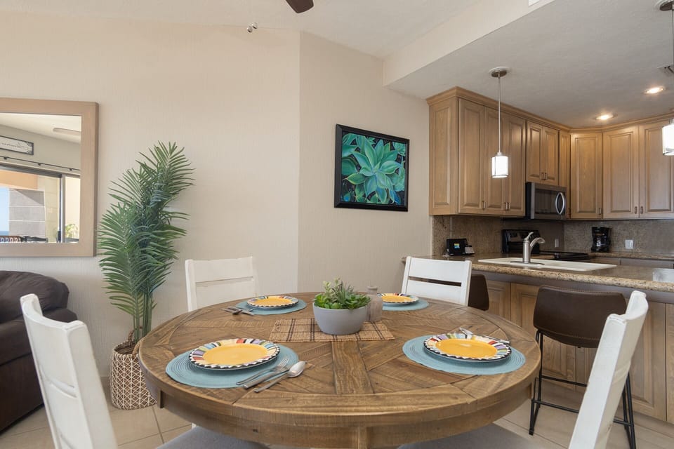 The dining table is neat he kitchen.