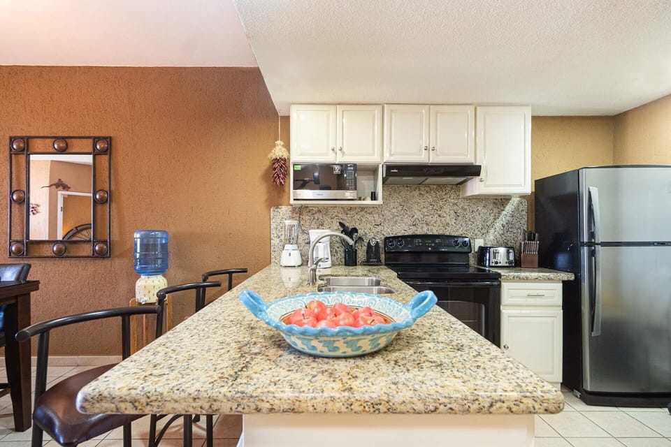The kitchen offers a large counter top with additional seating