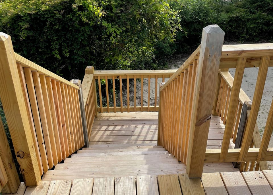 Your private deck stairway leads to outdoor adventures, with beautiful natural surroundings creating a peaceful retreat setting.