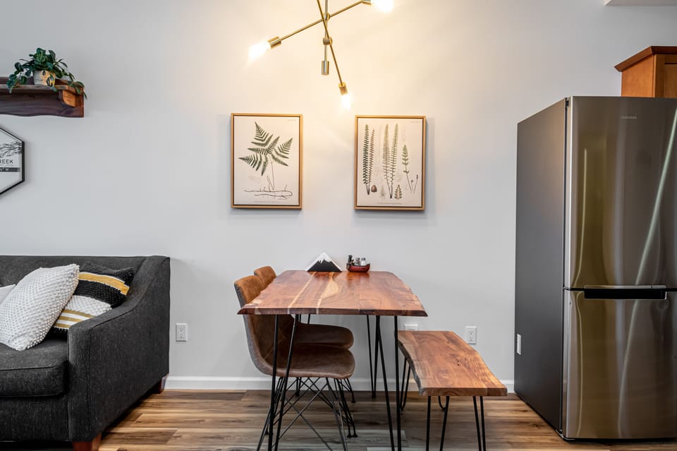 New live edge acacia wood dining table and local fern wall prints 