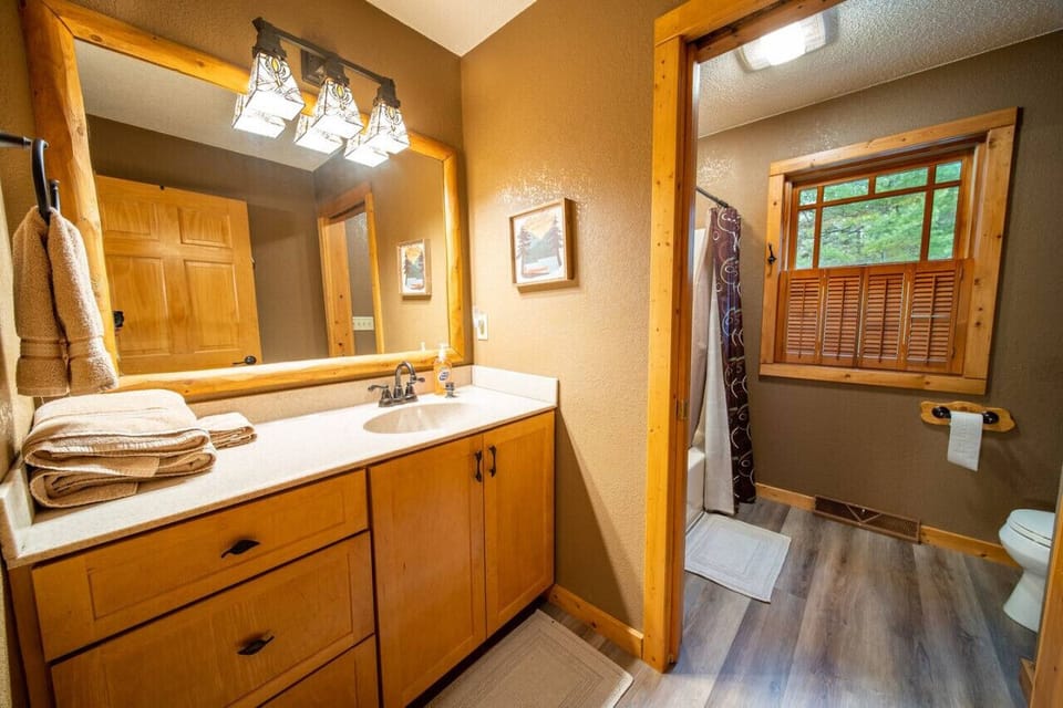 Main-level bathroom near the two main level bedrooms. The pocket door separates the shower from the sink.