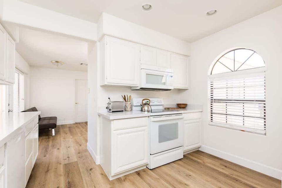 The fully equipped modern kitchen is stocked with all culinary essentials and breakfast bar seating.