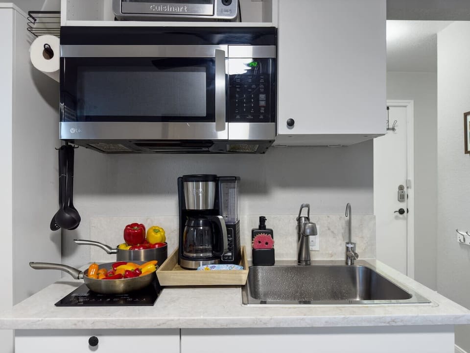Microwave, stovetop, coffee maker, and mini oven
