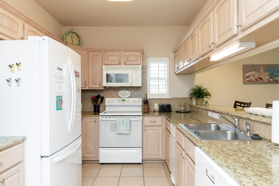 Your fully equipped kitchen awaits with granite countertops, stainless appliances, and everything needed to prepare your favorite meals.