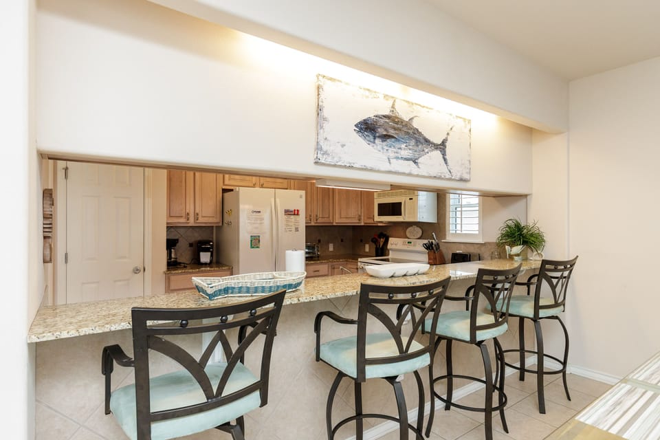 Gather around your spacious kitchen island for morning coffee or casual meals, with granite counters and coastal charm welcoming you home.