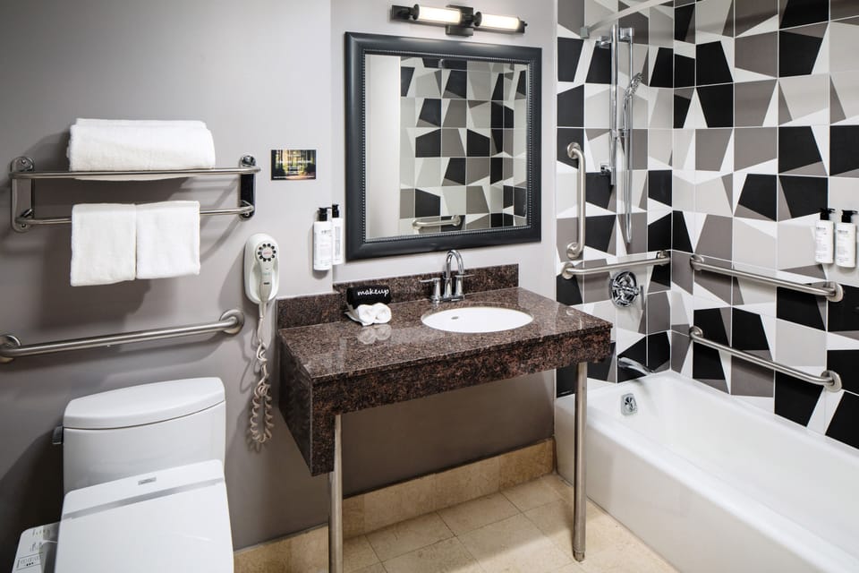 Room, 1 King Bed, Accessible | Bathroom | Combined shower/tub, hair dryer, bathrobes, slippers