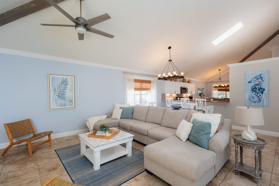 Comfortable sectional seating and coastal-inspired décor create a welcoming space to unwind after a day at the beach.
