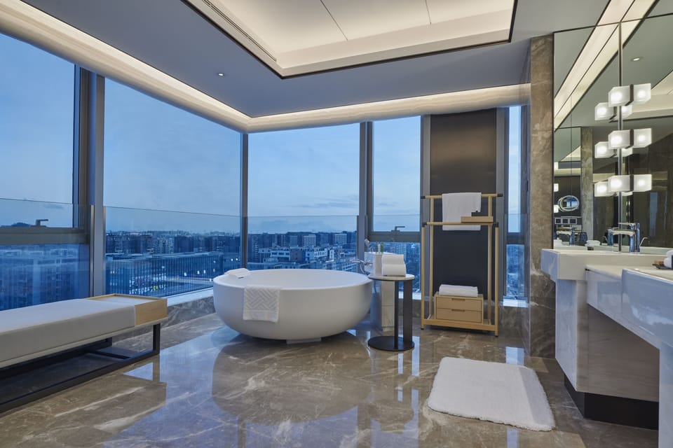Deluxe Suite, 1 King Bed | Bathroom | Separate tub and shower, bathrobes, slippers, towels