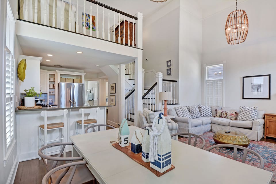 Open Living Area from the Kitchen - Kitchen bar, dining table, living room, and stairway connect through the center of the cottage.