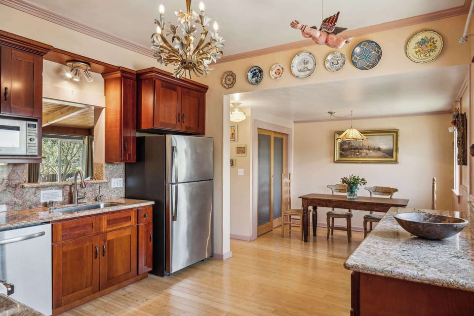 Charming kitchen with warm wood cabinets, stainless appliances, and a cozy adjoining dining area—full of character and perfect for home-cooked meals.
