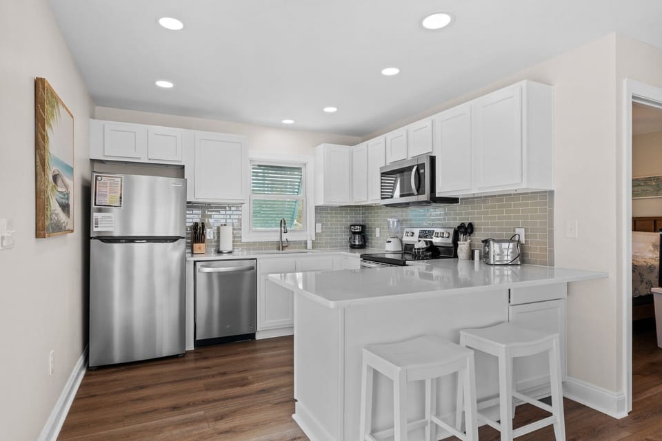 Upgraded kitchen w counter height bar stools and brand new stainless appliances