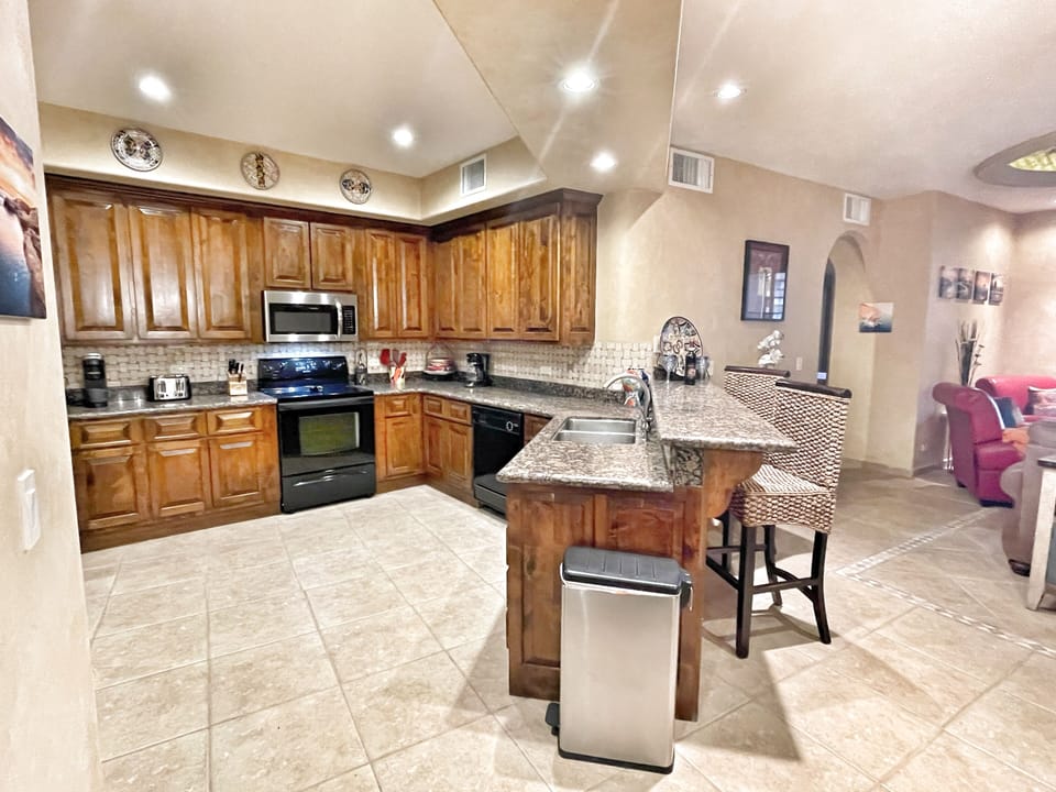 Spacious, fully stocked kitchen with updated stainless steel appliances