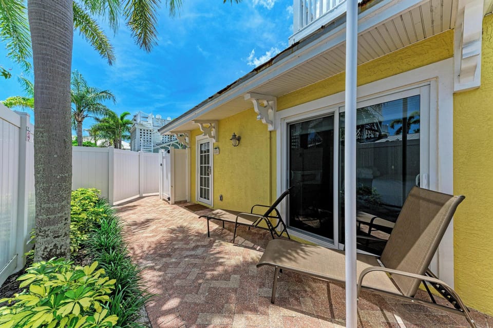 Your private patio offers a peaceful retreat with sunny loungers and lush tropical greenery, perfect for morning coffee or evening relaxation in the warm Florida breeze.