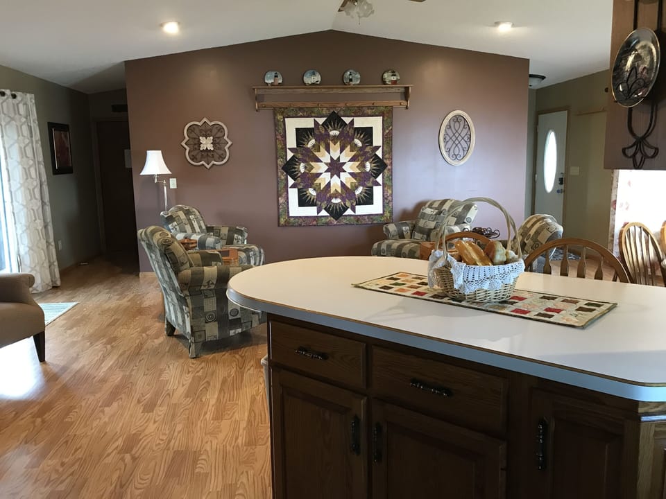 Family room with comfy seating and beautiful views of Lake Pepin. Also has a tv.