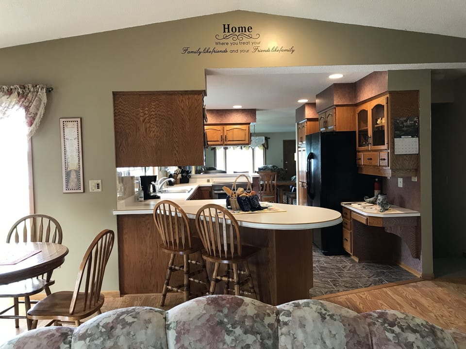 Looking from family room through kitchen, dining room and into living room.