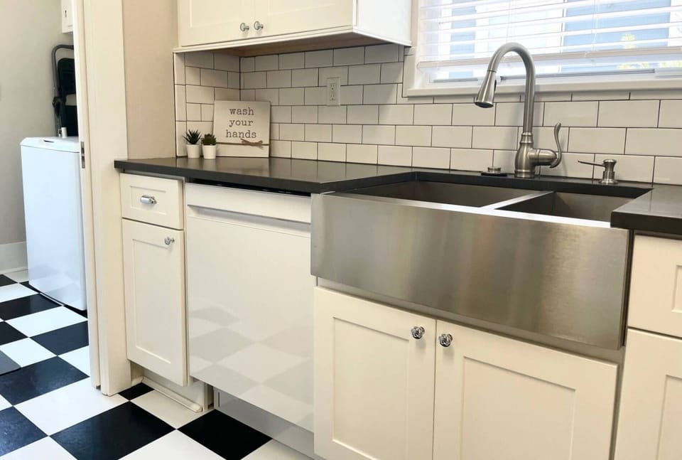 Large stainless steel farmhouse sink with a window
