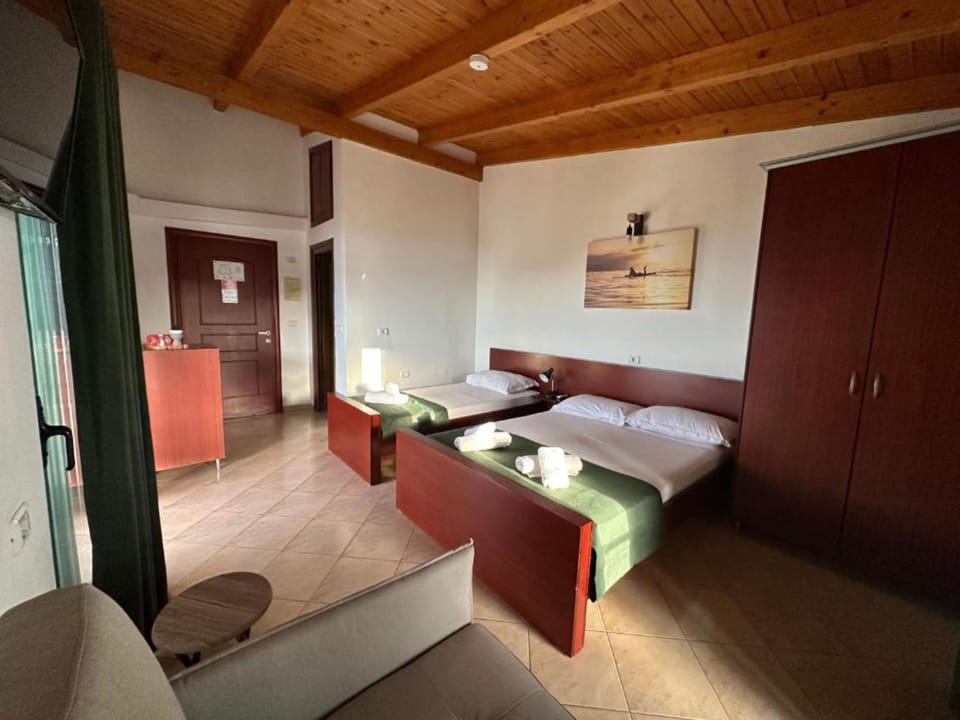 Quadruple Room, Sea View | Desk, free WiFi, bed sheets