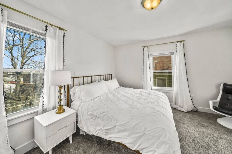 This is the back bedroom with a comfortable King size bed.  There is also a dresser for your clothes with a smart tv.  Go through this bedroom to get to the upstairs full bathroom.  Open the blinds for nice views of the trail during the day.