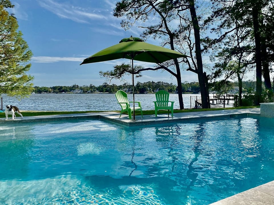 Custom new waterfront pool, swim spa, and waterfall.  