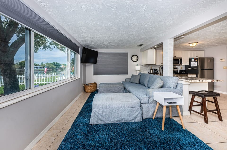 Open and airy beach inspired family room with Roku TV and lake views