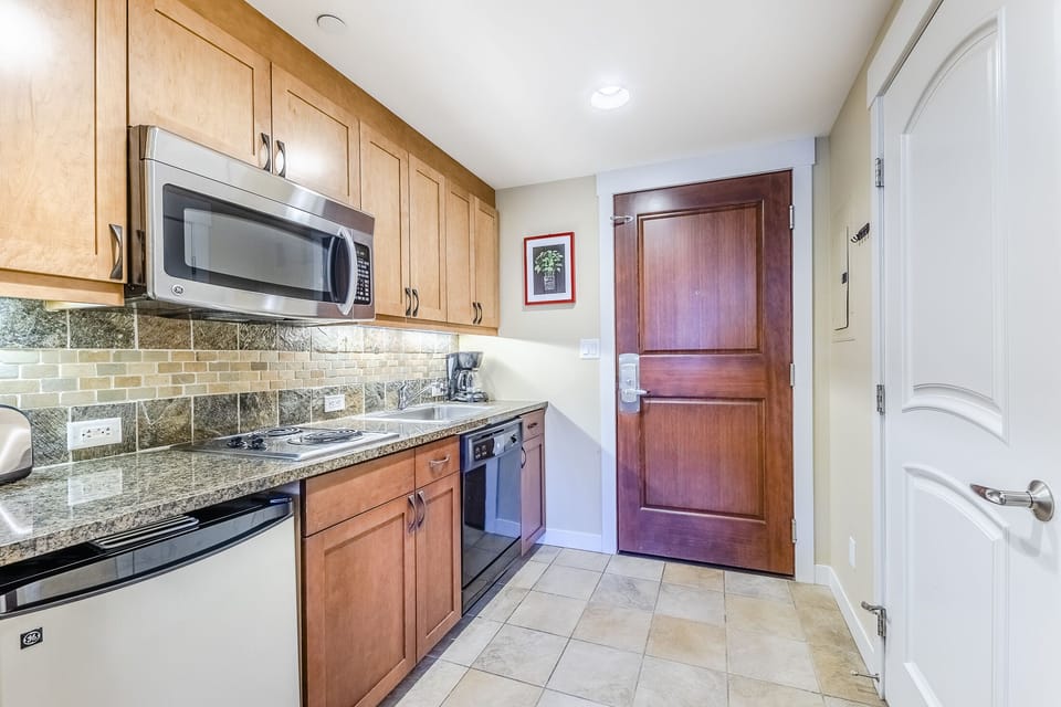 Kitchen - Kitchen- Cozy kitchenette with two in-counter burners, mini fridge, dishwasher, and above range microwave.