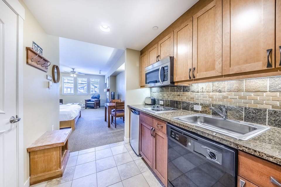 Kitchen - Kitchen- Cozy kitchenette with two in-counter burners, mini fridge, dishwasher, and above range microwave.
