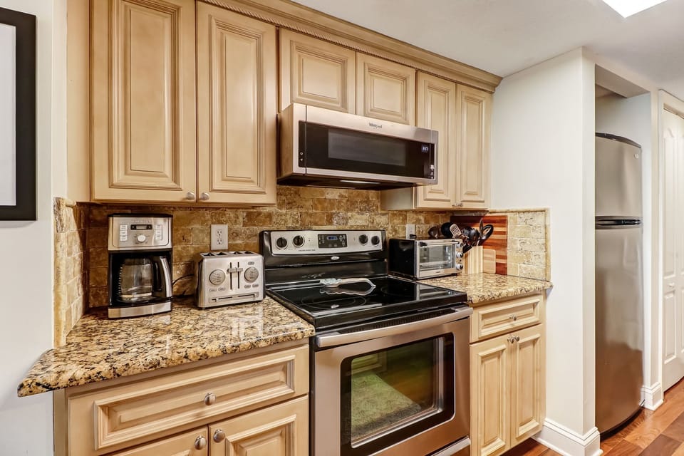Fully Equipped Luxury Kitchen with Stainless Steel Appliances and Handsome Granite Countertops