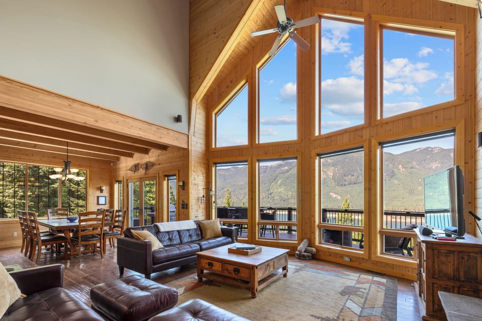 Open concept living room and dining room with views.