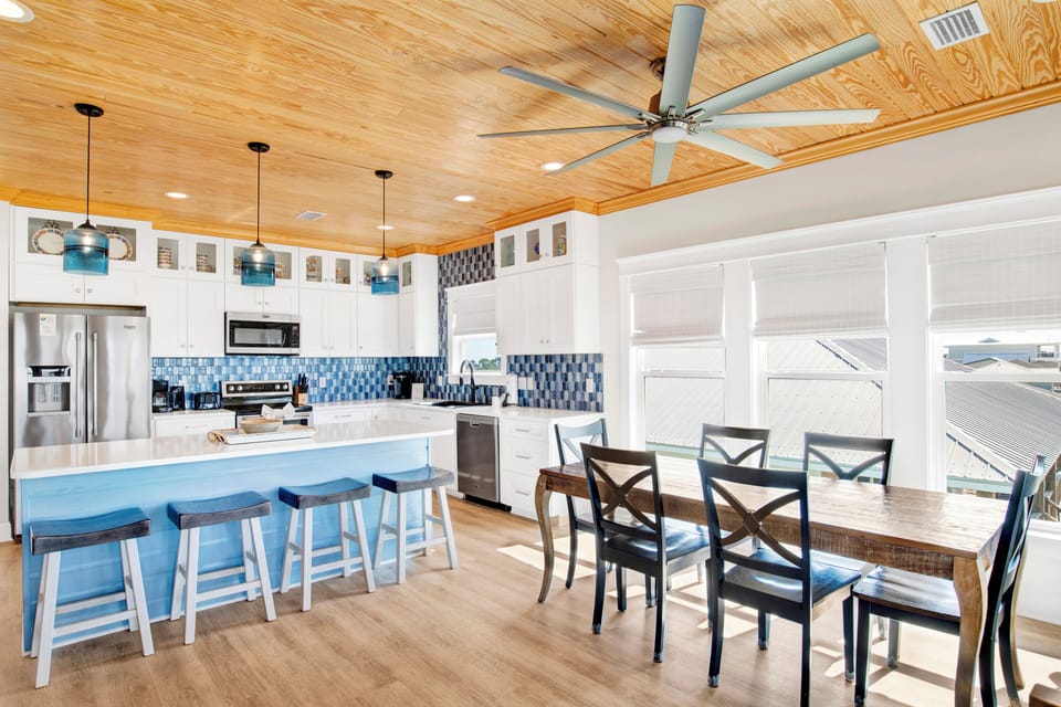 Seating for 6 at the dining room table with additional seating at the bar
