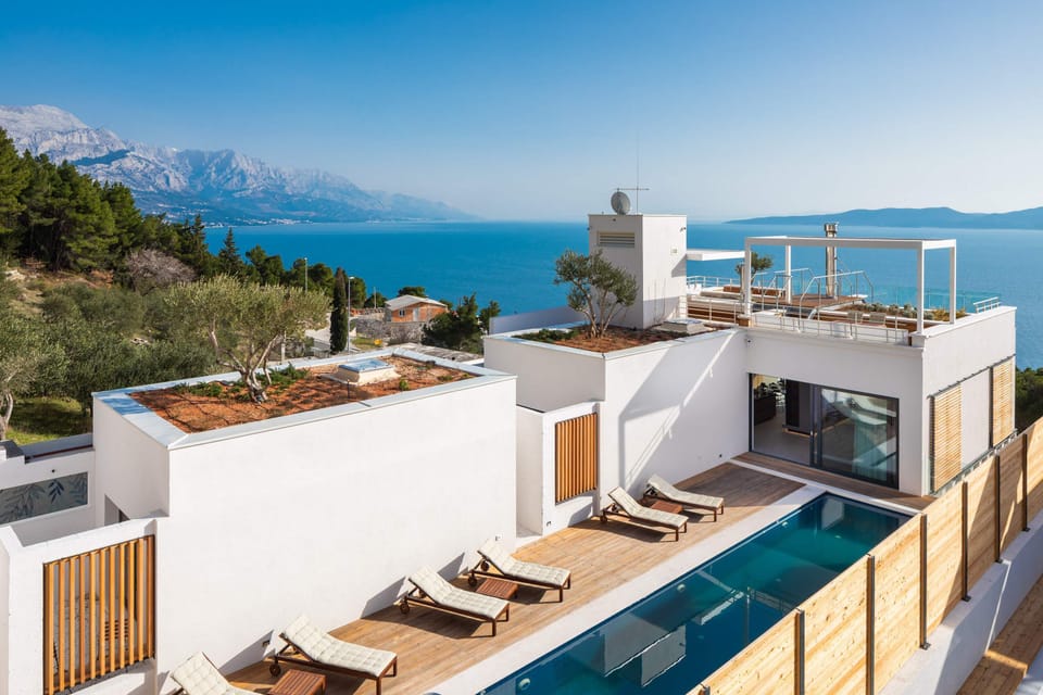 A rooftop area approachable by elevator offers a barbecue area, a kitchenette...