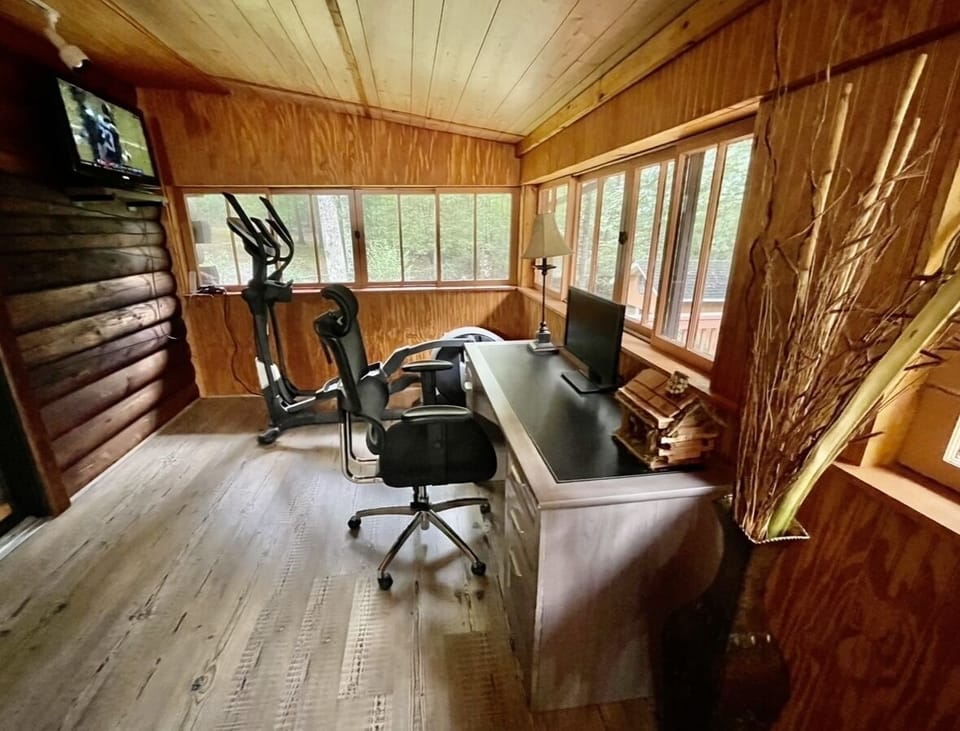 Office Space w/ Desk and Monitor and Fitness Space w/ Elliptical, Yoga Mat & TV