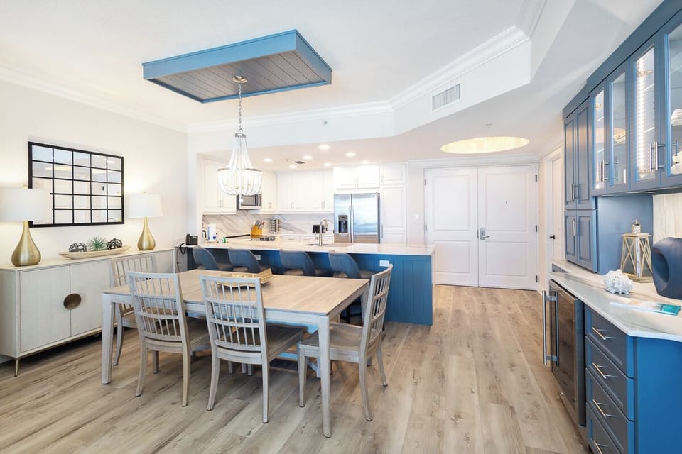 Step into your stunning open-concept kitchen where coastal blue cabinetry meets modern convenience—perfect for creating memorable meals together.
