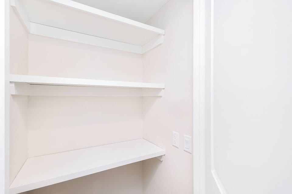 Your walk-in closet offers generous storage with multiple shelves and hanging space to keep your belongings perfectly organized.