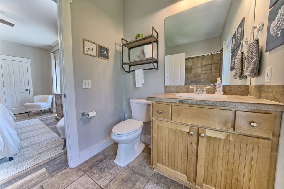 Full bathroom with single vanity, toilet, and shower. Conveniently located off a bedroom for guest privacy and comfort.